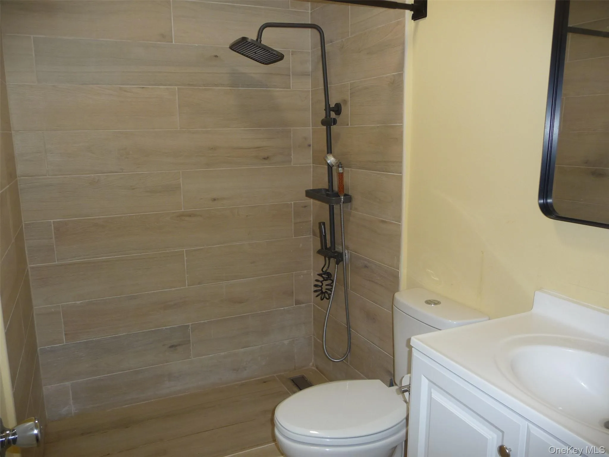 Full bathroom featuring vanity and tiled shower Full bathroom featuring vanity and tiled shower