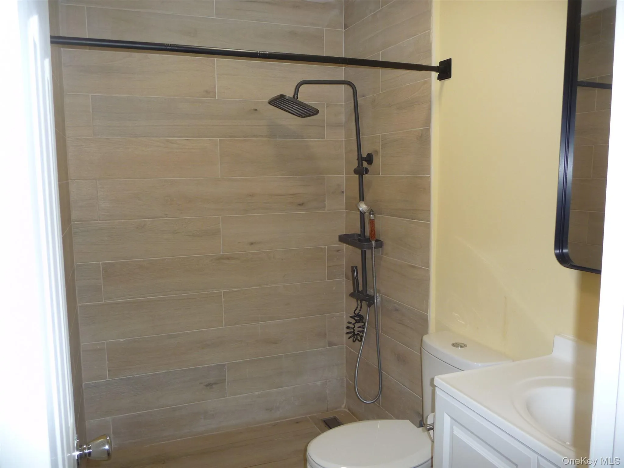 Bathroom with vanity and tiled shower Bathroom with vanity and tiled shower