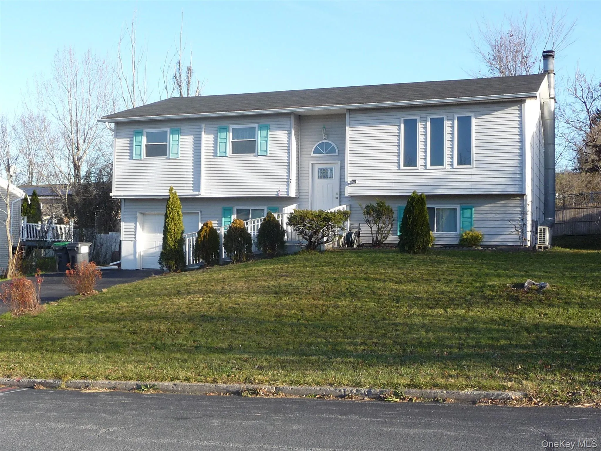 Bi-level home with driveway and a garage Bi-level home with driveway and a garage