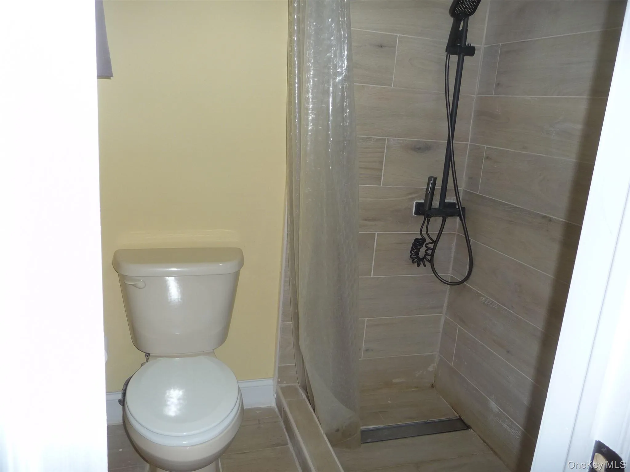 Full bath with a shower stall and toilet Full bath with a shower stall and toilet