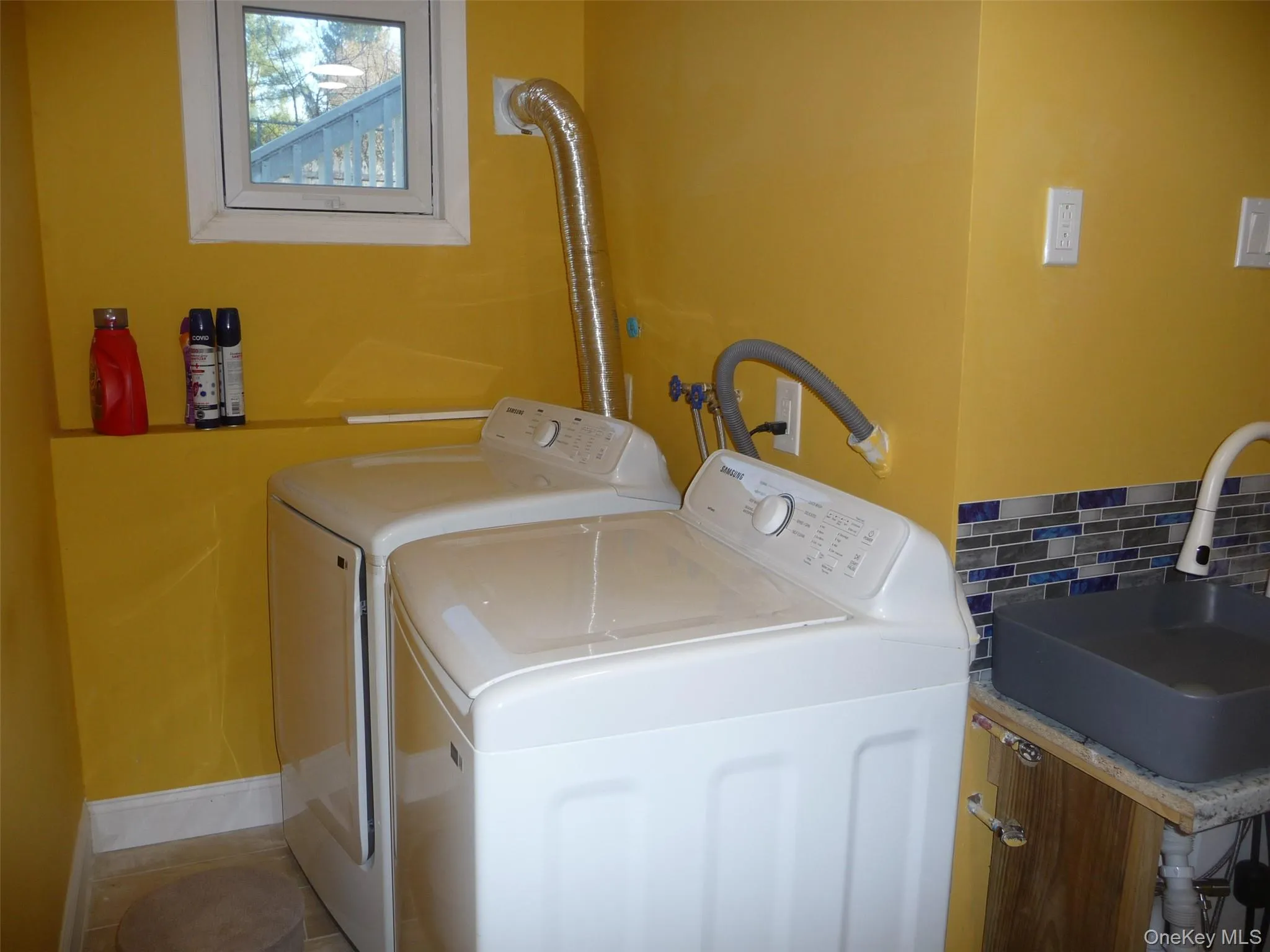 Laundry area with washing machine and clothes dryer and baseboards Laundry area with washing machine and clothes dryer and baseboards