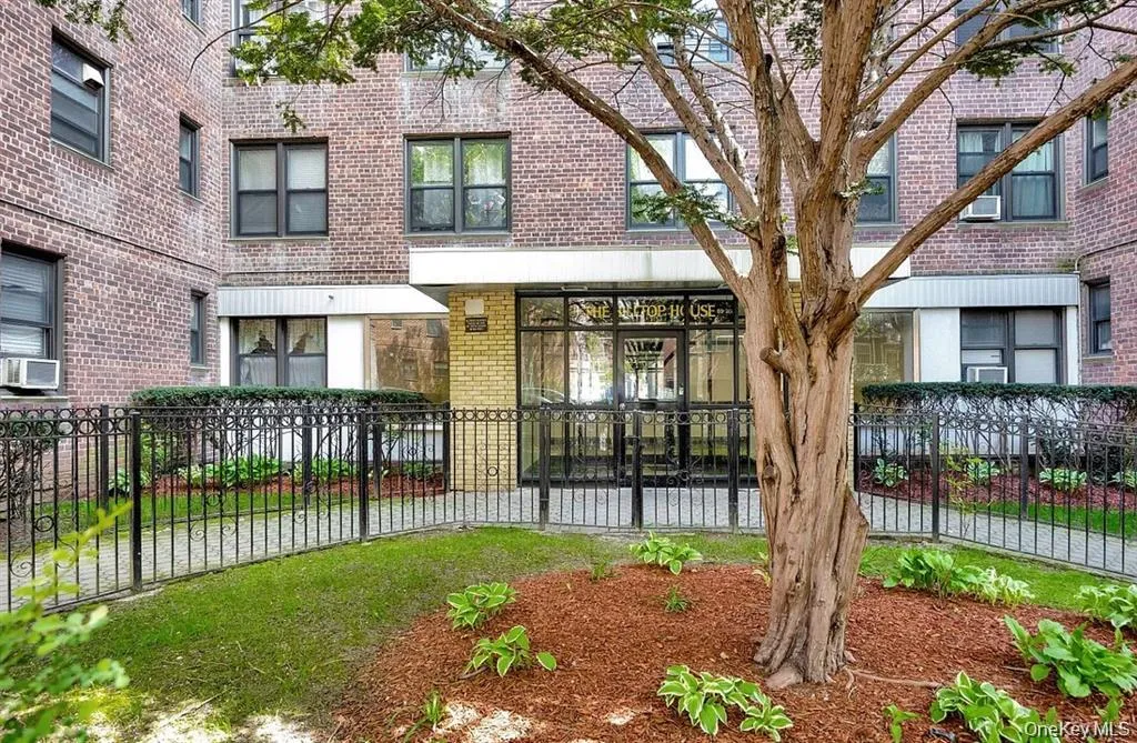 View of front of home featuring a fenced front yard and brick siding View of front of home featuring a fenced front yard and brick siding