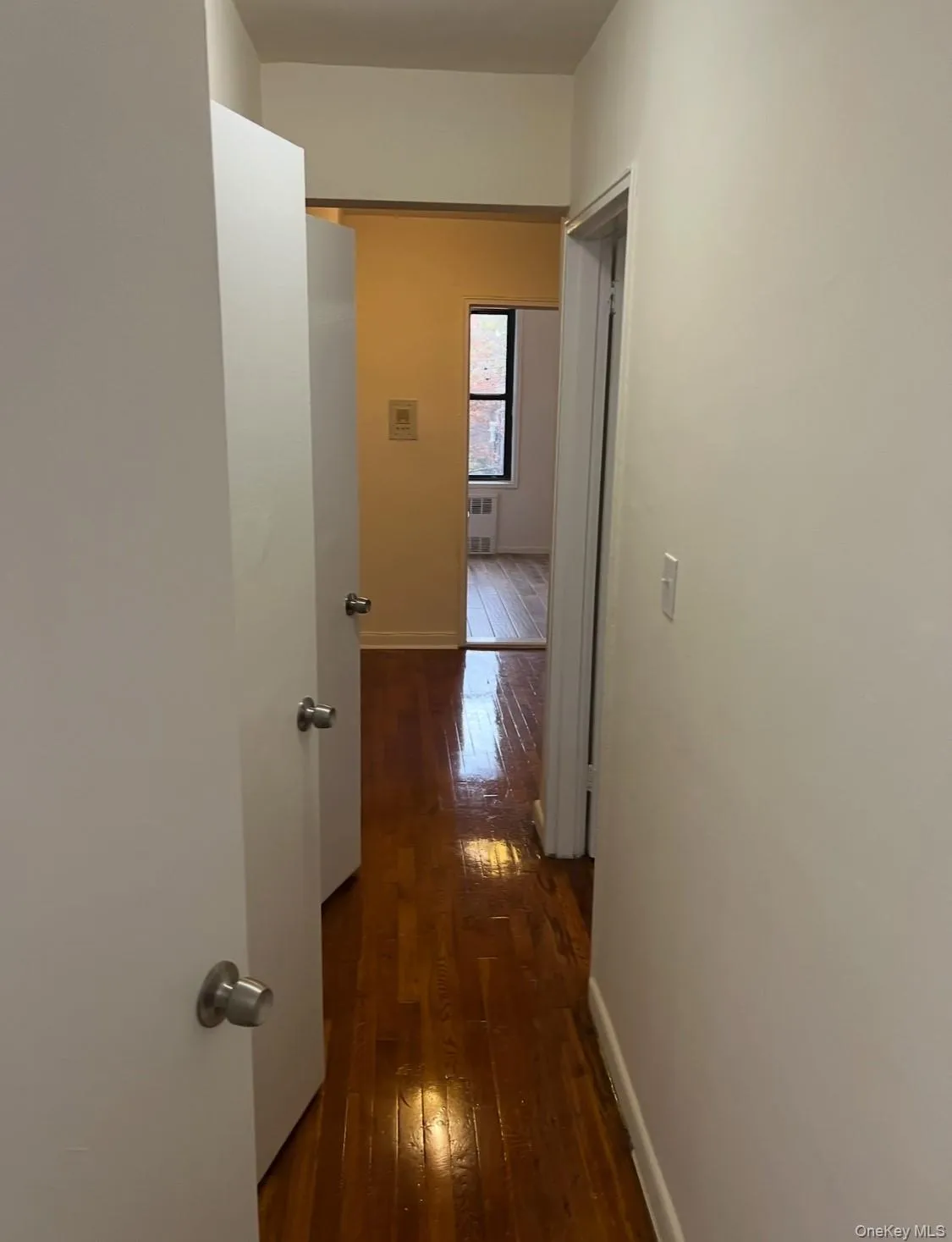 Hall featuring dark wood-style floors Hall featuring dark wood-style floors