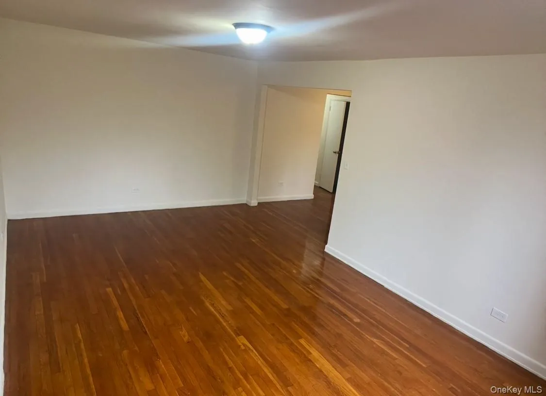 Unfurnished room with dark wood-style floors Unfurnished room with dark wood-style floors