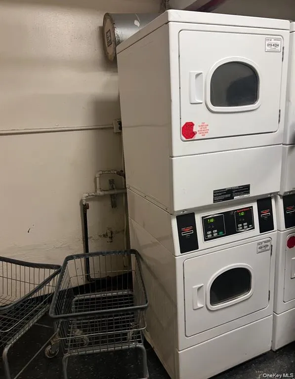 Laundry area with stacked washing machine and dryer Laundry area with stacked washing machine and dryer