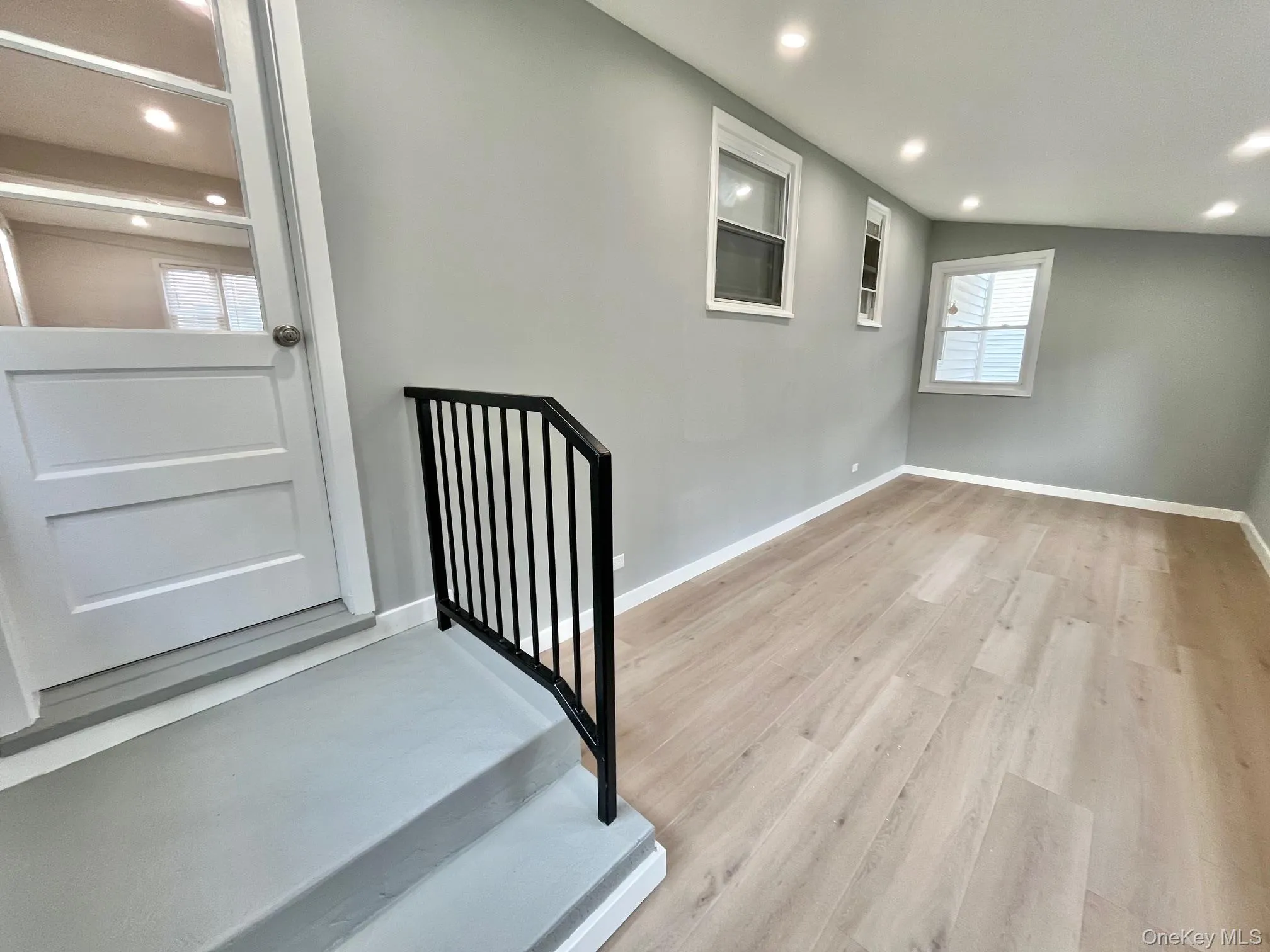 Staircase with recessed lighting and wood finished floors Staircase with recessed lighting and wood finished floors