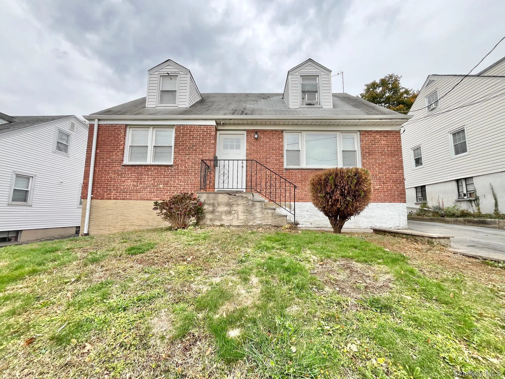 View of front facade featuring brick siding and a front lawn View of front facade featuring brick siding and a front lawn