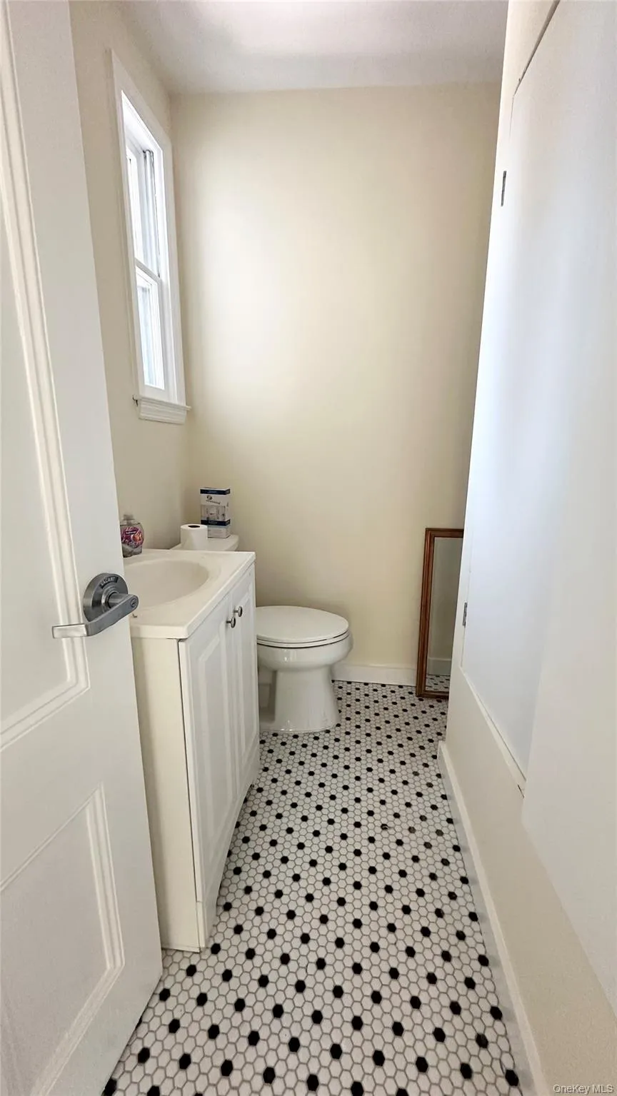 Bathroom featuring tile patterned floors, vanity, and toilet Bathroom featuring tile patterned floors, vanity, and toilet