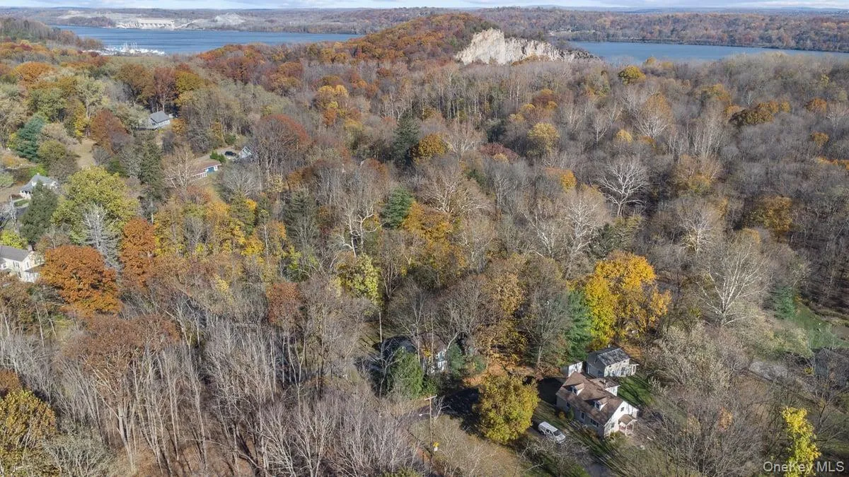 Aerial overview of property's location with a forest and a nearby body of water Aerial overview of property's location with a forest and a nearby body of water