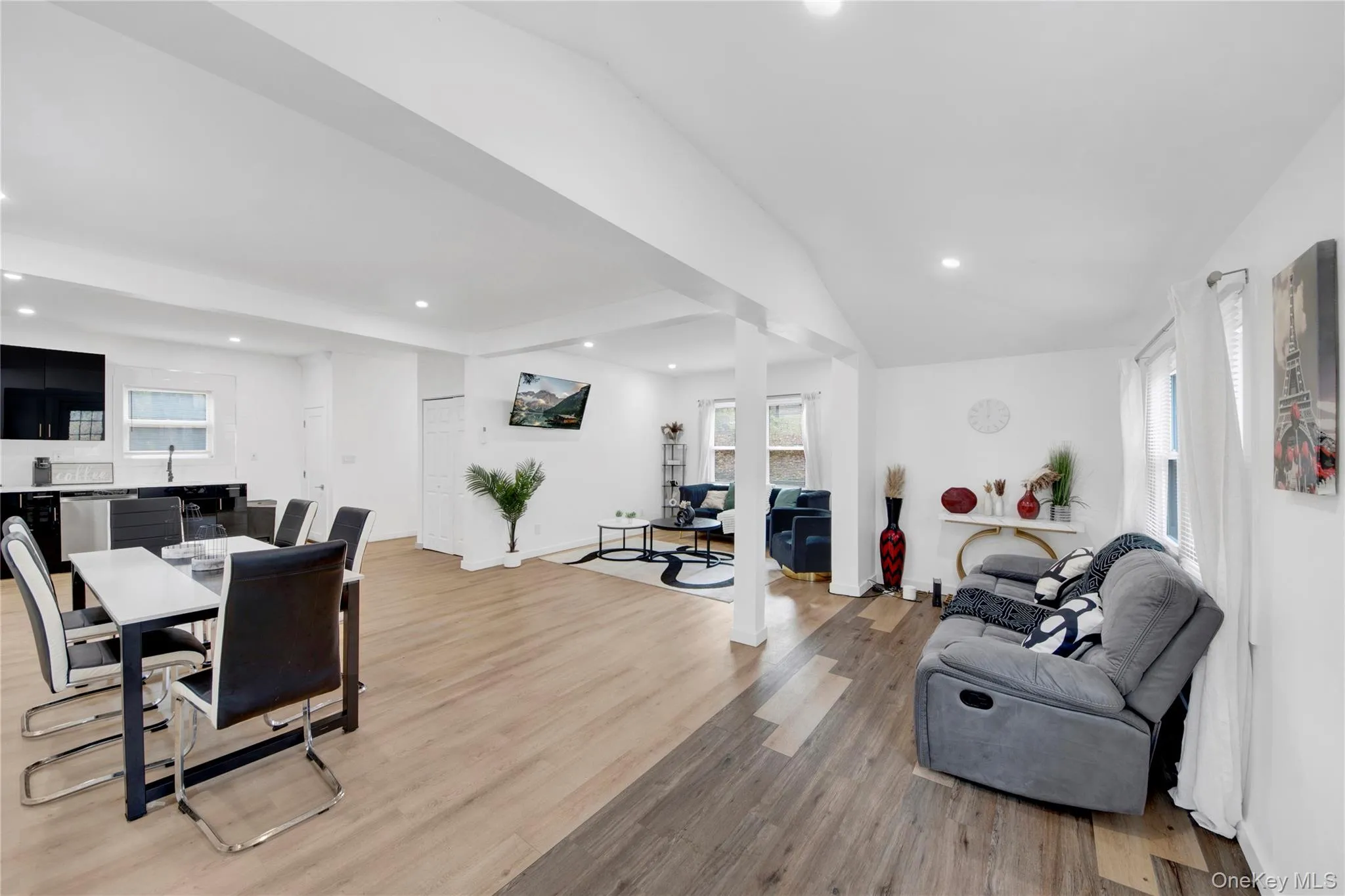 Living area with recessed lighting, light wood-type flooring, and beam ceiling Living area with recessed lighting, light wood-type flooring, and beam ceiling