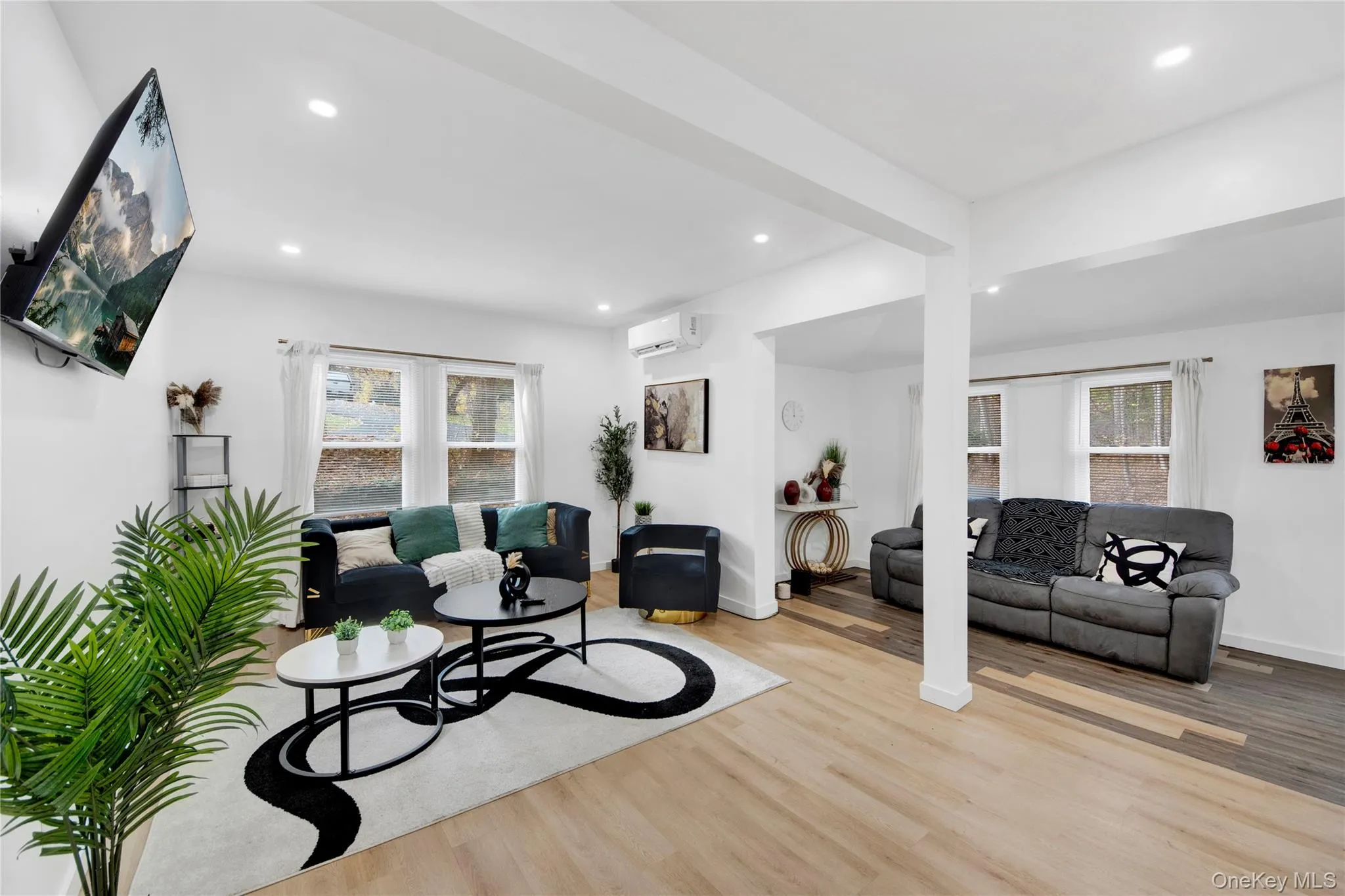 Living room featuring wood finished floors, healthy amount of natural light, and recessed lighting Living room featuring wood finished floors, healthy amount of natural light, and recessed lighting