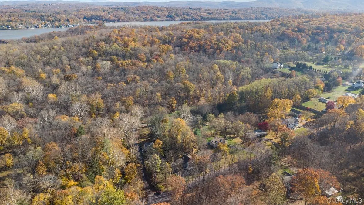View of property location with a heavily wooded area and a large body of water View of property location with a heavily wooded area and a large body of water