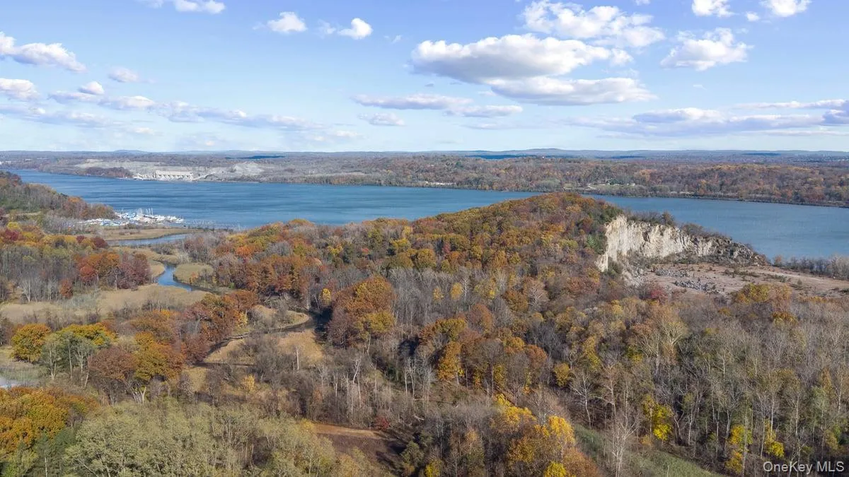 Aerial view of property and surrounding area featuring a large body of water Aerial view of property and surrounding area featuring a large body of water