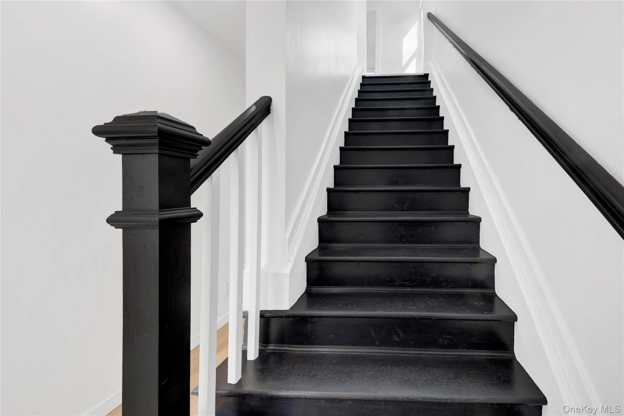 Stairway with wood finished floors and baseboards Stairway with wood finished floors and baseboards