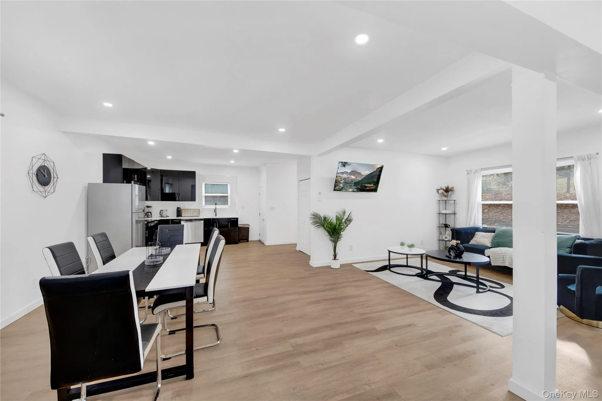 Dining area with recessed lighting, light wood-style floors, and beamed ceiling Dining area with recessed lighting, light wood-style floors, and beamed ceiling