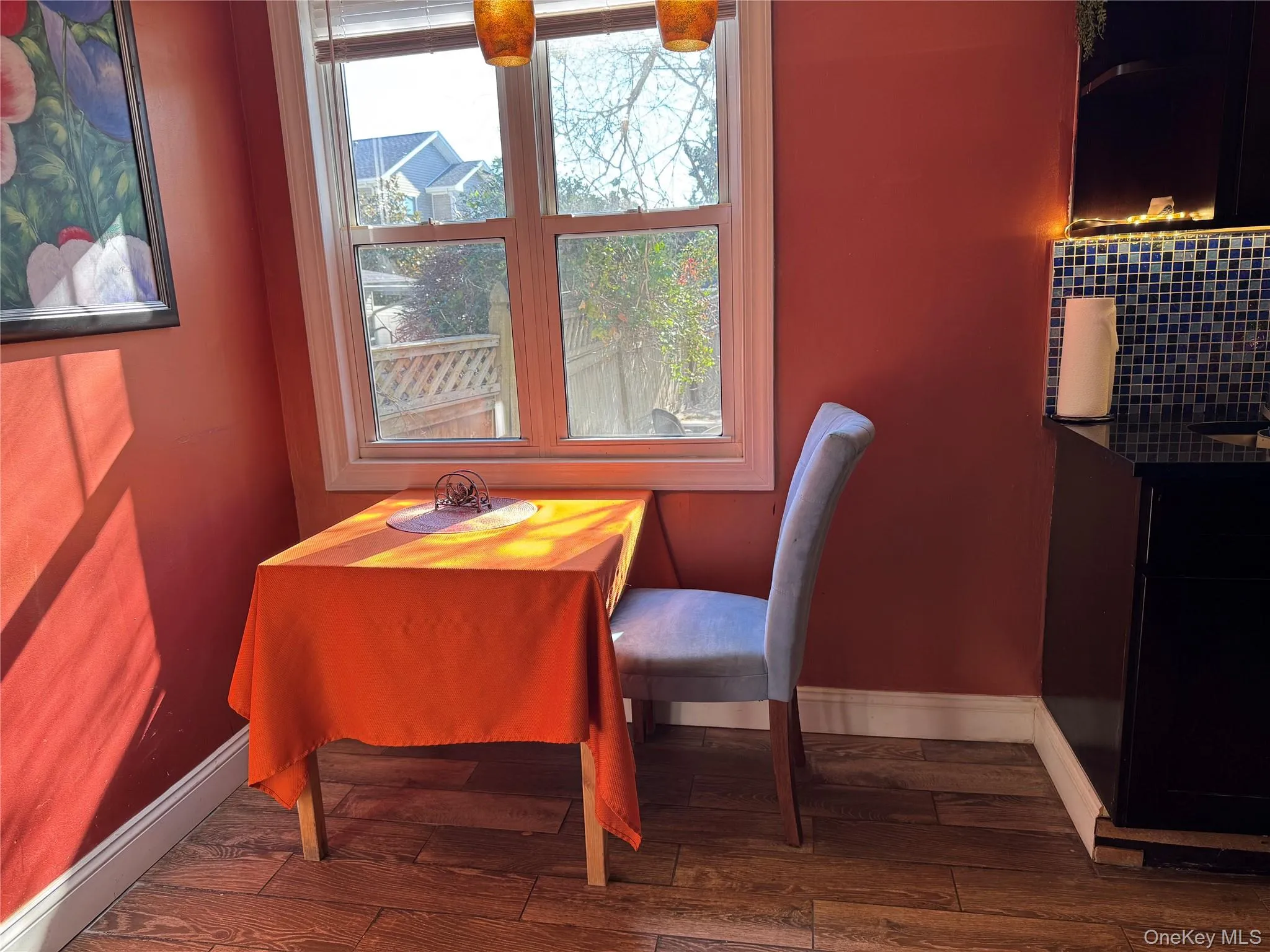Dining area with dark wood-type flooring Dining area with dark wood-type flooring