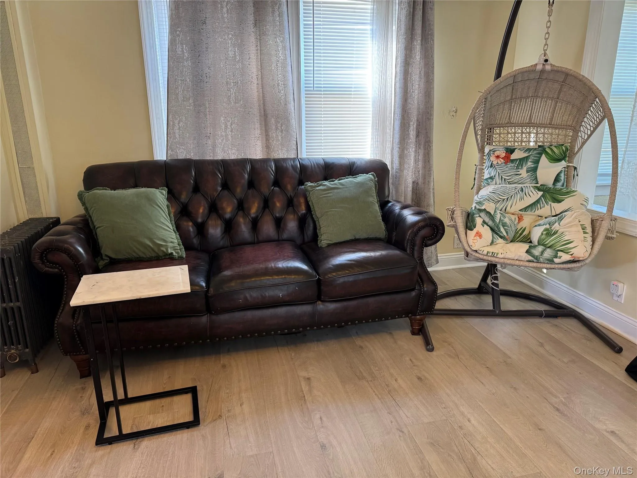 Living room featuring light wood-style floors and baseboards Living room featuring light wood-style floors and baseboards