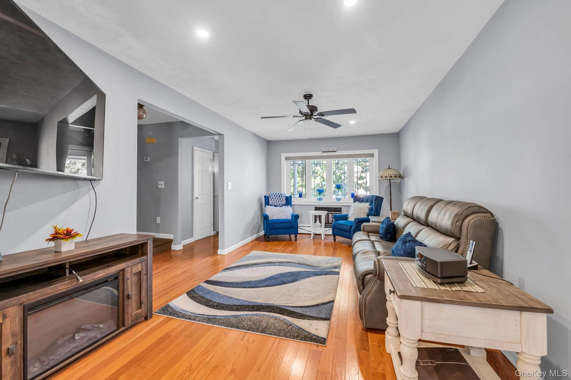 Living area with light wood-type flooring, recessed lighting, and ceiling fan Living area with light wood-type flooring, recessed lighting, and ceiling fan