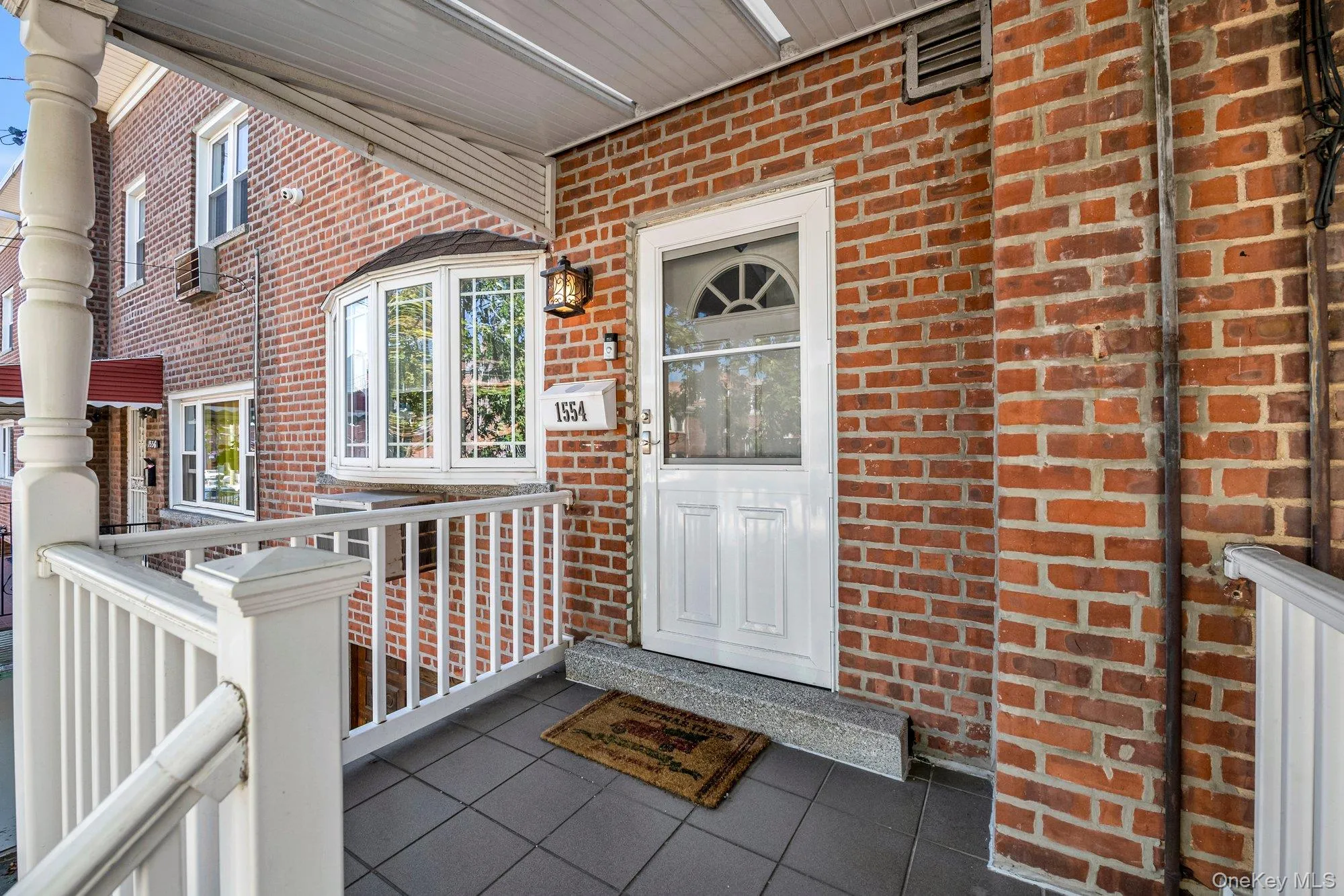 Entrance to property with covered porch and brick siding Entrance to property with covered porch and brick siding