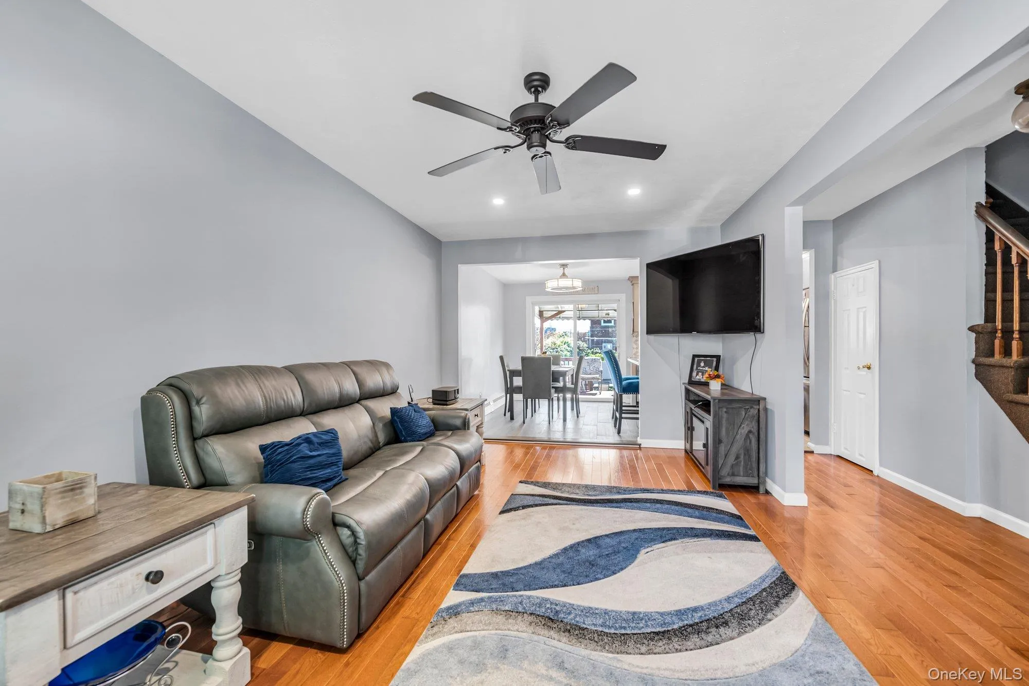 Living area with light wood finished floors, stairway, recessed lighting, and ceiling fan Living area with light wood finished floors, stairway, recessed lighting, and ceiling fan