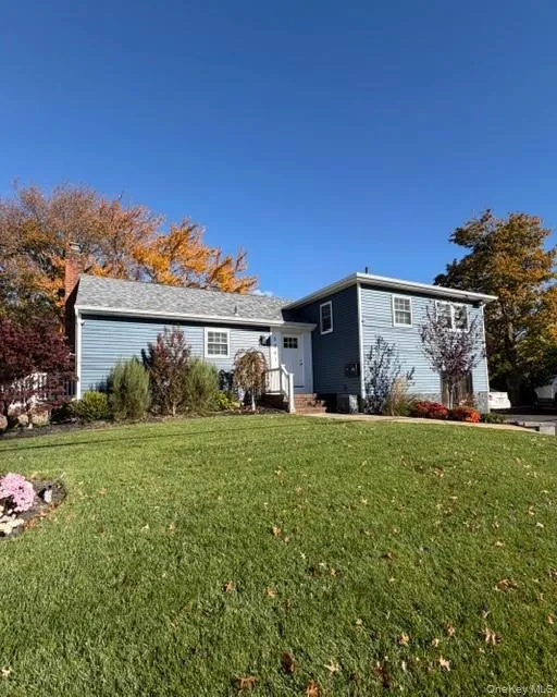View of front of house featuring a front yard and a chimney View of front of house featuring a front yard and a chimney