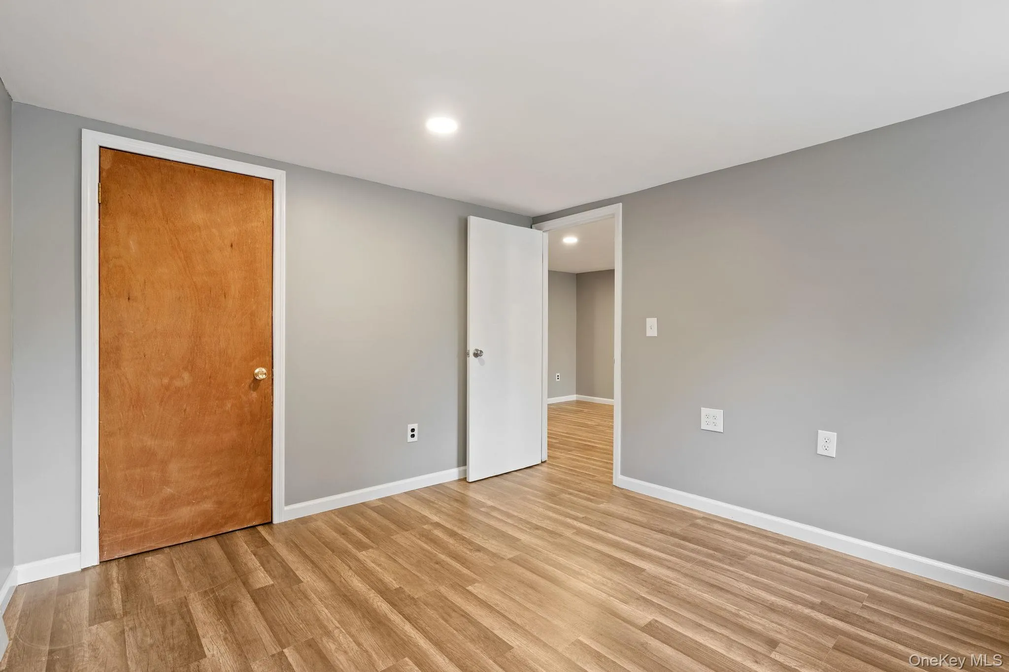 Unfurnished bedroom with light wood-style floors, recessed lighting, and a closet Unfurnished bedroom with light wood-style floors, recessed lighting, and a closet