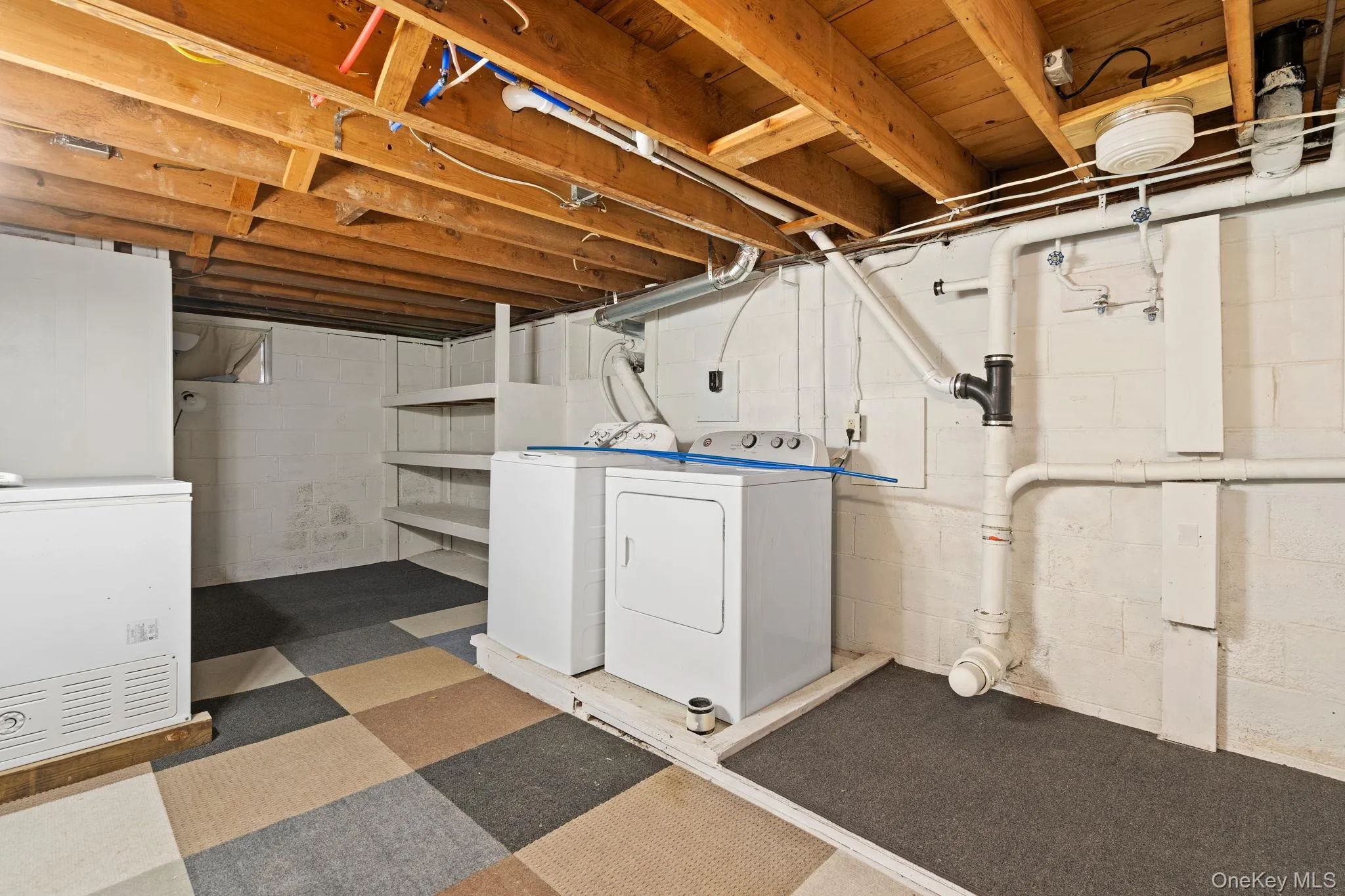 Unfinished basement with washing machine and clothes dryer Unfinished basement with washing machine and clothes dryer