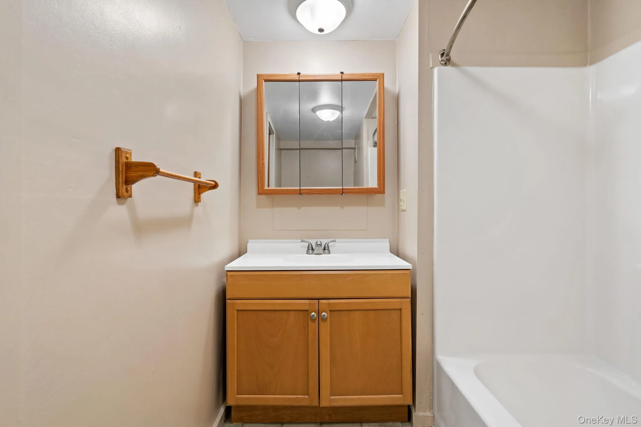 Bathroom featuring vanity and washtub / shower combination Bathroom featuring vanity and washtub / shower combination