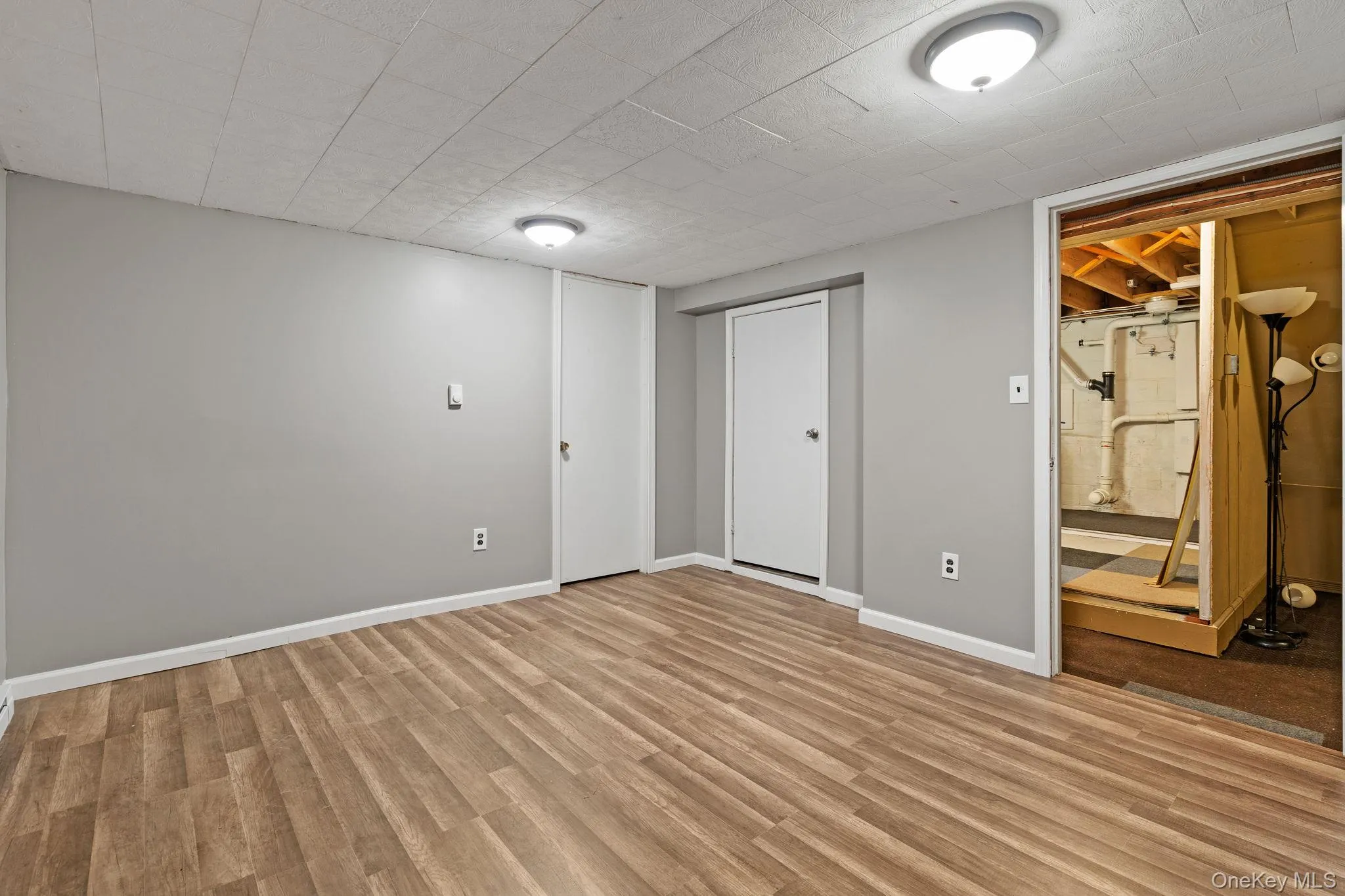 Finished basement with light wood-style floors and baseboards Finished basement with light wood-style floors and baseboards