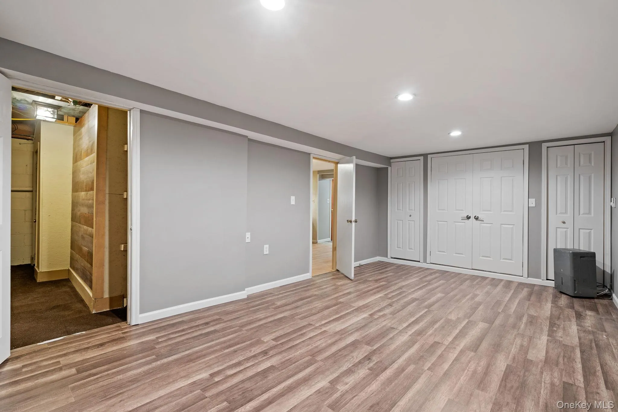 Finished basement with wood finished floors and recessed lighting Finished basement with wood finished floors and recessed lighting