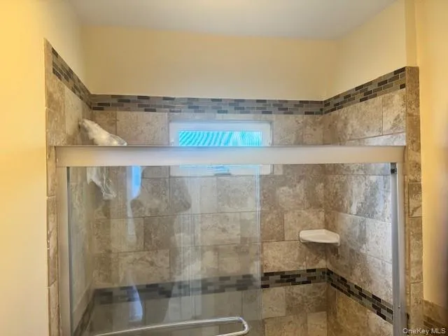 Full bath featuring a shower stall Full bath featuring a shower stall