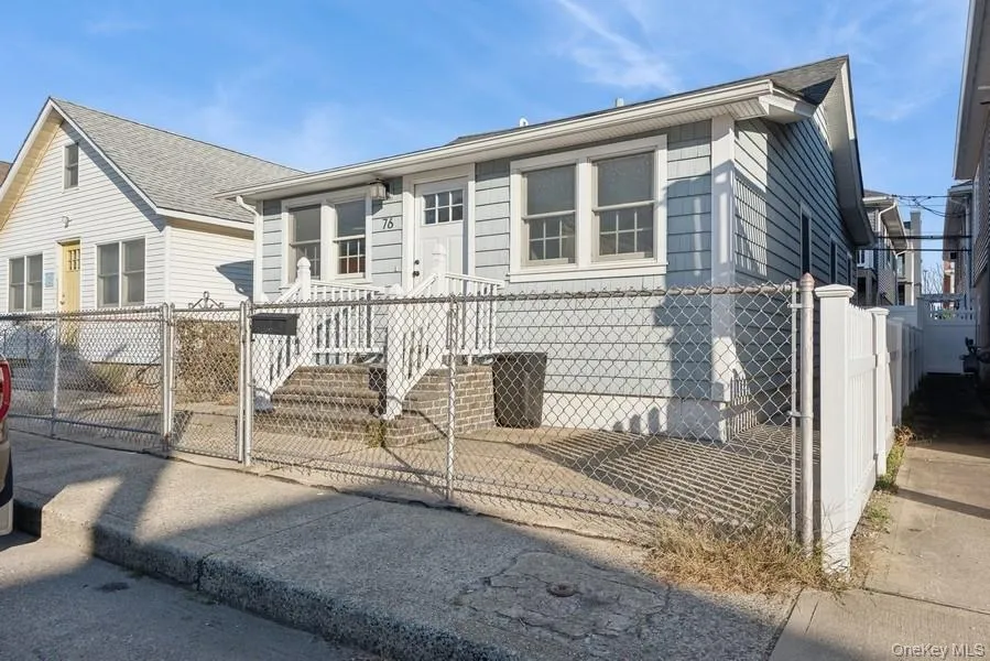 View of front facade with a fenced front yard and a gate View of front facade with a fenced front yard and a gate