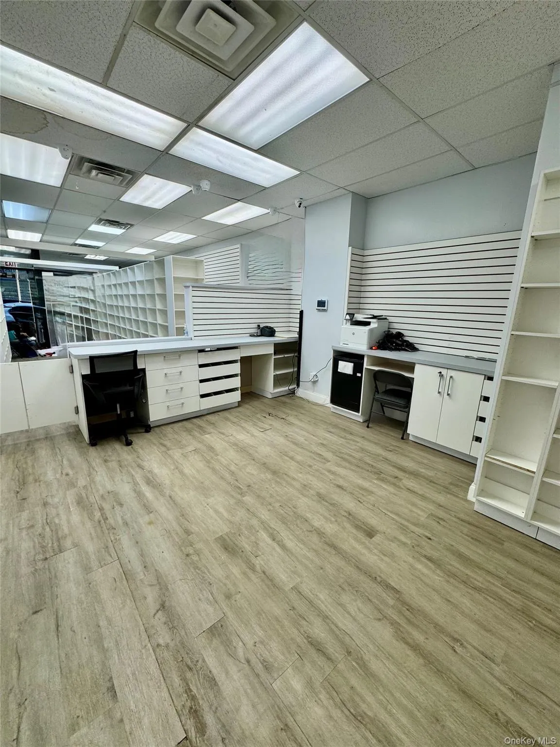 Office area featuring a drop ceiling and light wood-type flooring Office area featuring a drop ceiling and light wood-type flooring