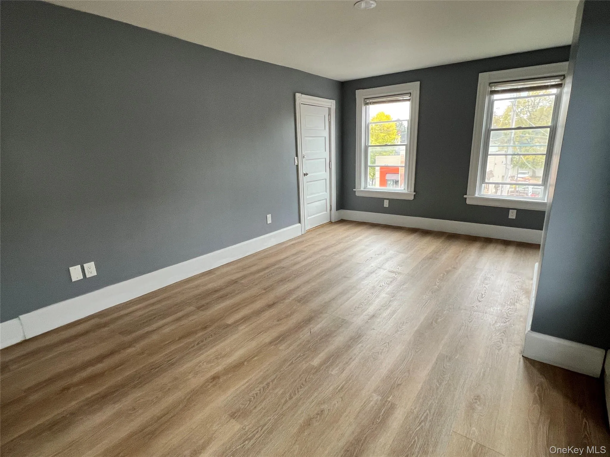 Empty room featuring baseboards and light wood-style floors Empty room featuring baseboards and light wood-style floors