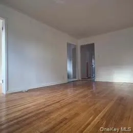 Spare room with wood finished floors and baseboards Spare room with wood finished floors and baseboards