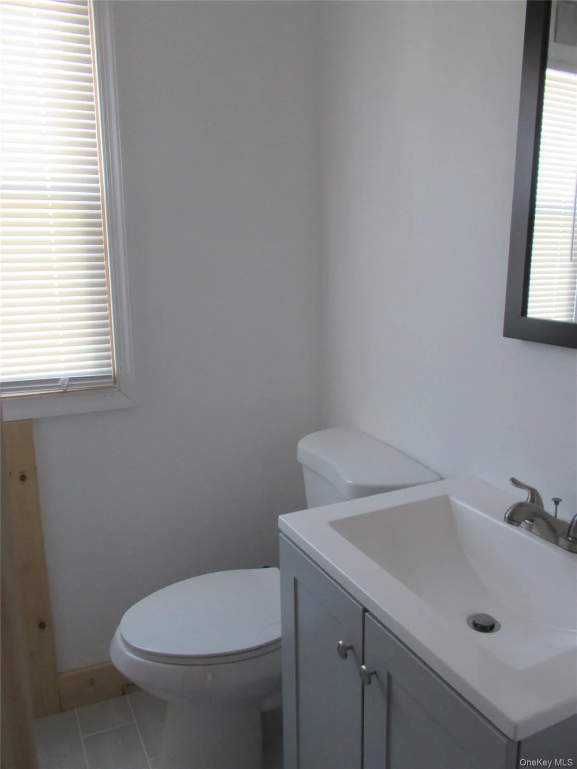 Bathroom featuring light tile patterned flooring and vanity Bathroom featuring light tile patterned flooring and vanity