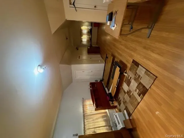 Bedroom with light wood finished floors and lofted ceiling Bedroom with light wood finished floors and lofted ceiling