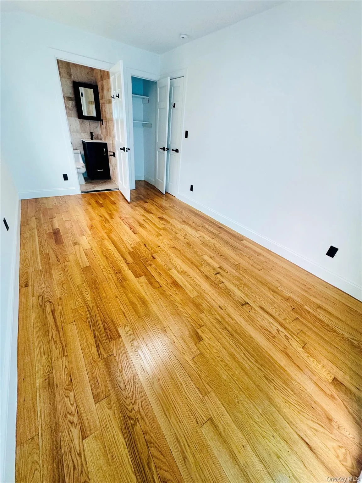 Unfurnished bedroom featuring light wood-type flooring and baseboards Unfurnished bedroom featuring light wood-type flooring and baseboards