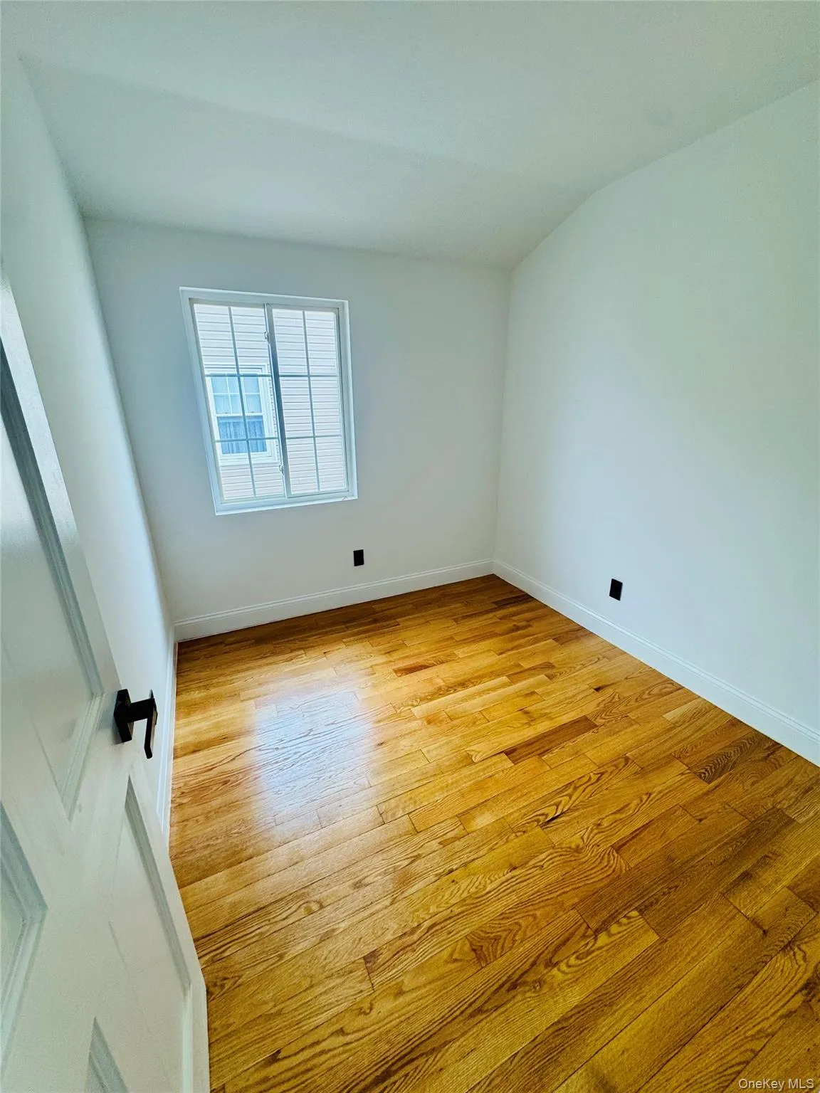 Spare room with baseboards and light wood finished floors Spare room with baseboards and light wood finished floors