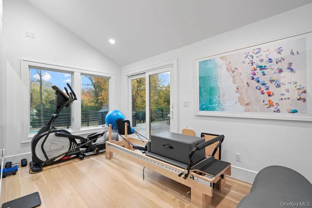 Workout area with light wood-type flooring, recessed lighting, plenty of natural light, and high vaulted ceiling Workout area with light wood-type flooring, recessed lighting, plenty of natural light, and high vaulted ceiling