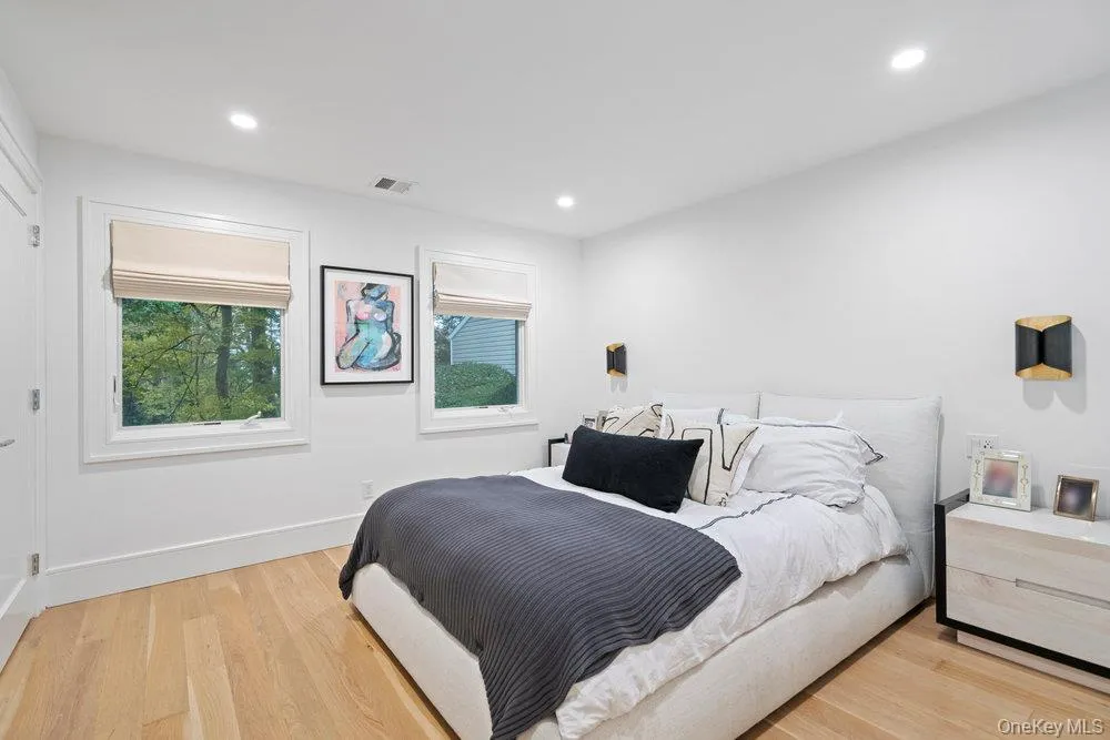 Bedroom featuring light wood-type flooring and recessed lighting Bedroom featuring light wood-type flooring and recessed lighting