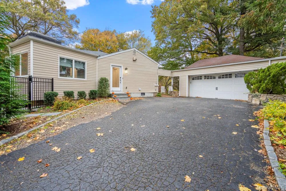View of front facade with a garage, driveway, an outdoor structure, and entry steps View of front facade with a garage, driveway, an outdoor structure, and entry steps
