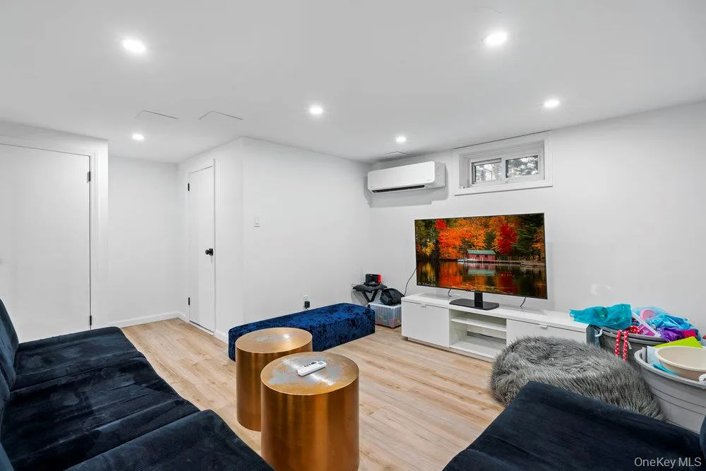 Living area with wood finished floors and recessed lighting Living area with wood finished floors and recessed lighting