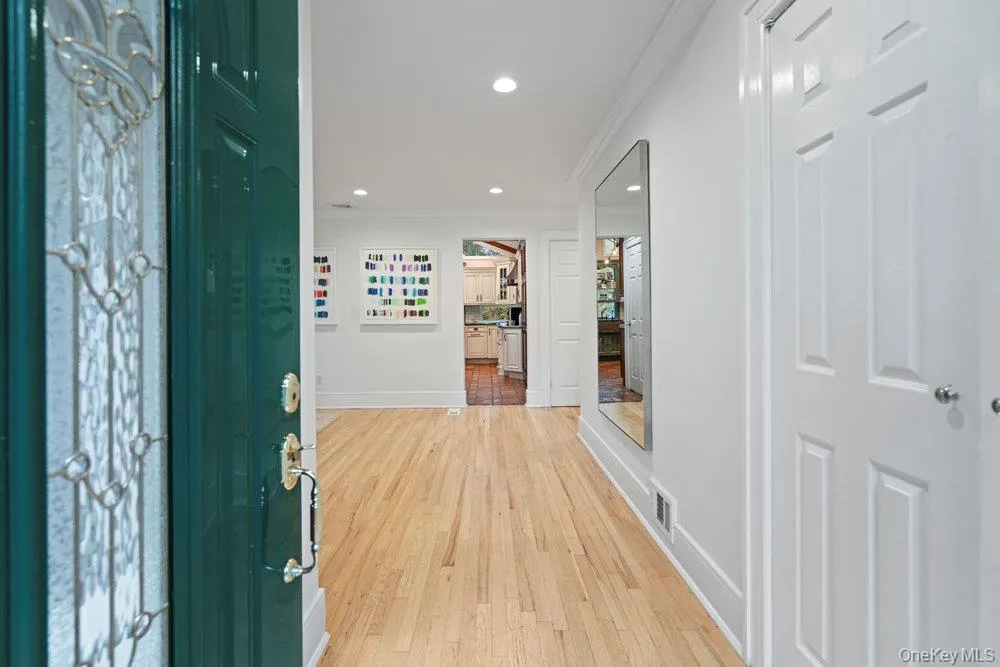 Entrance foyer with light wood finished floors, recessed lighting, and ornamental molding Entrance foyer with light wood finished floors, recessed lighting, and ornamental molding