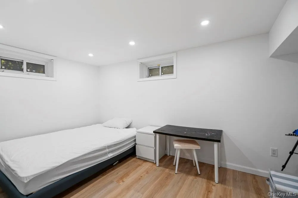 Bedroom featuring light wood-style floors and recessed lighting Bedroom featuring light wood-style floors and recessed lighting