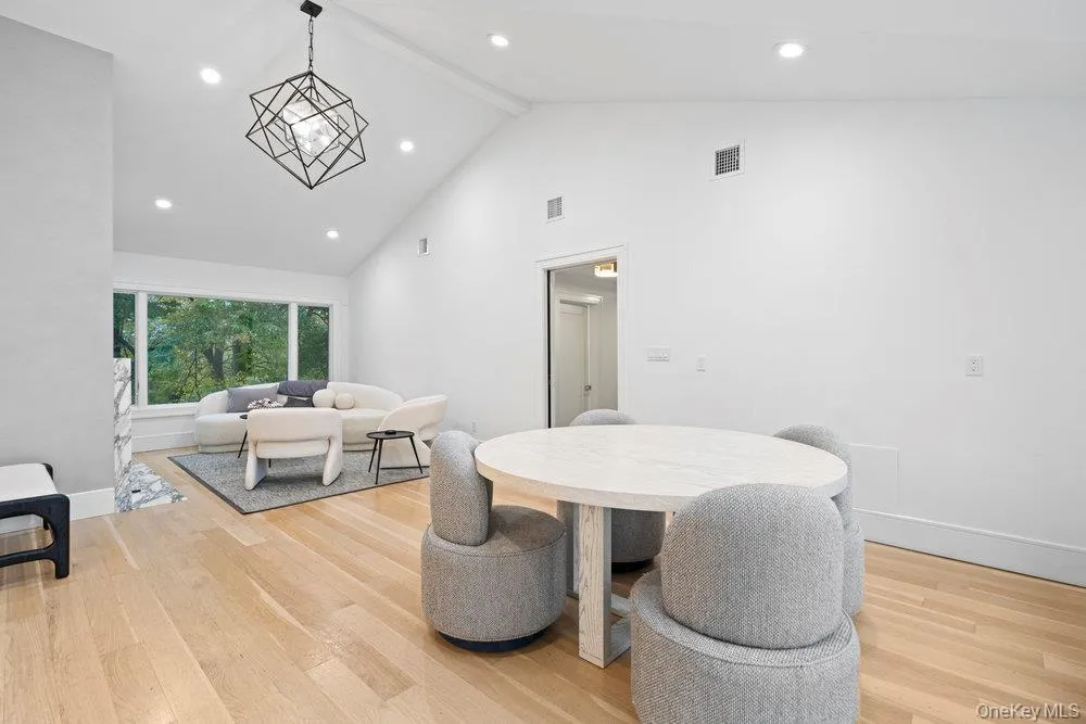 Dining space featuring high vaulted ceiling, recessed lighting, light wood-type flooring, and beamed ceiling Dining space featuring high vaulted ceiling, recessed lighting, light wood-type flooring, and beamed ceiling