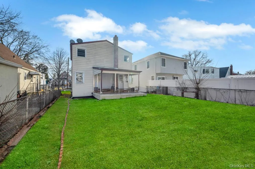 Back of house featuring a fenced backyard and a chimney Back of house featuring a fenced backyard and a chimney