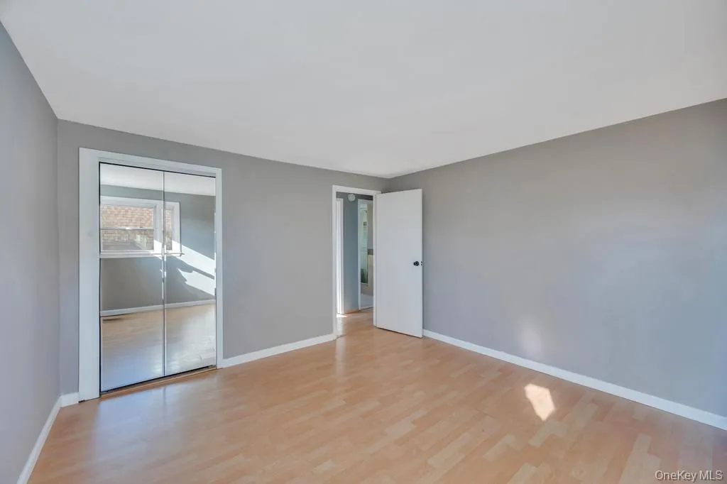 Spare room with light wood-type flooring and baseboards Spare room with light wood-type flooring and baseboards