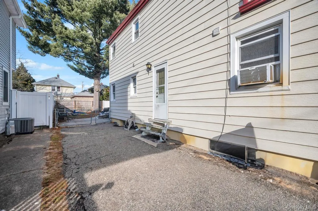 View of side of property featuring a gate and a patio View of side of property featuring a gate and a patio