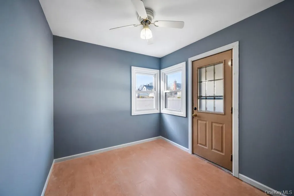 Doorway to outside featuring wood finished floors and a ceiling fan Doorway to outside featuring wood finished floors and a ceiling fan